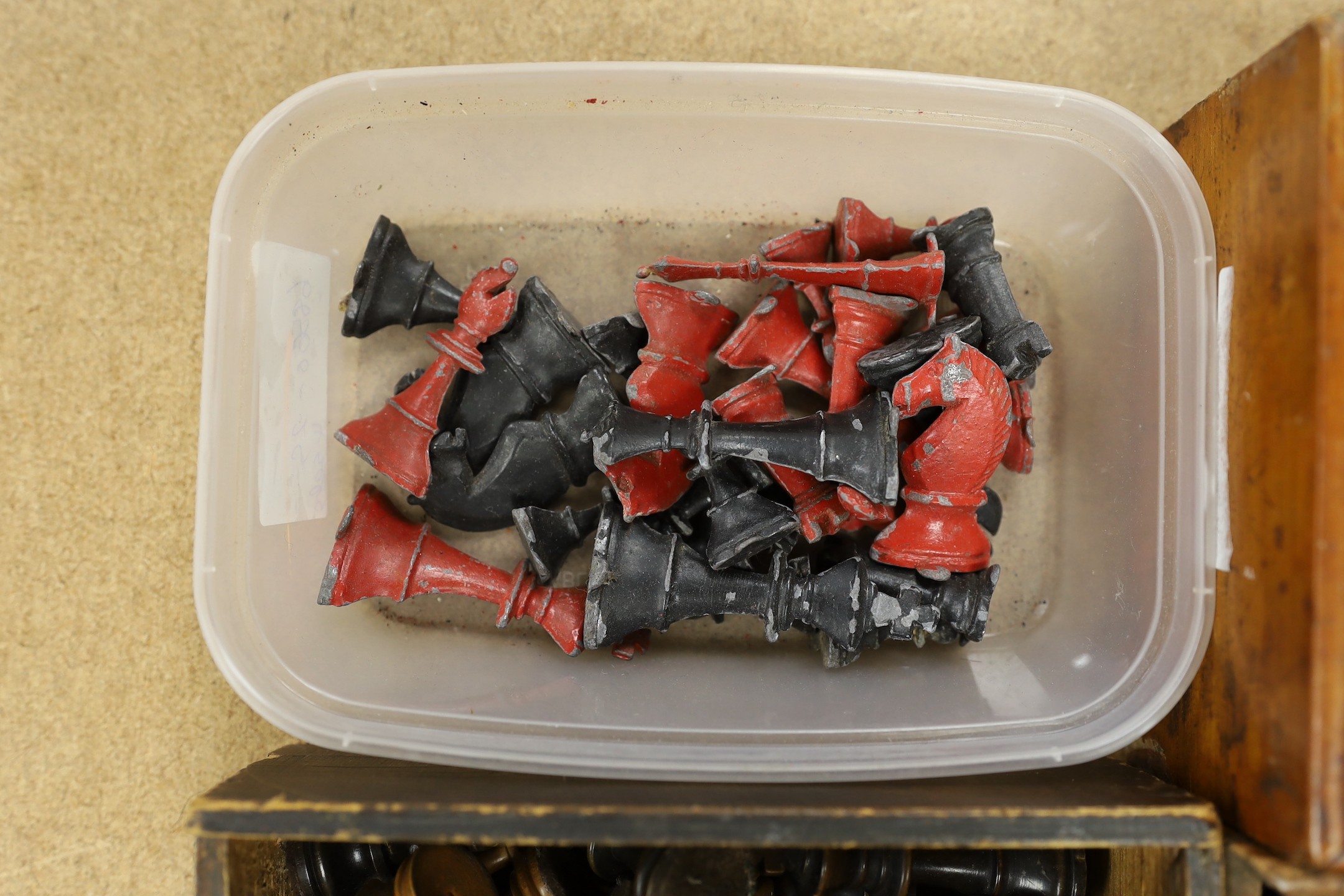 A painted lead chess set together with three boxed turned wooded chess sets.